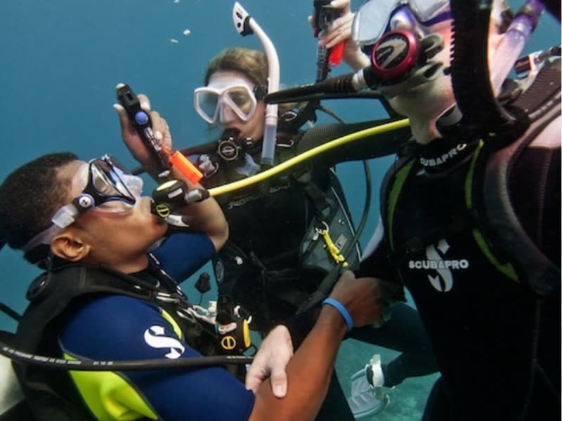 Instructor with two students underwater