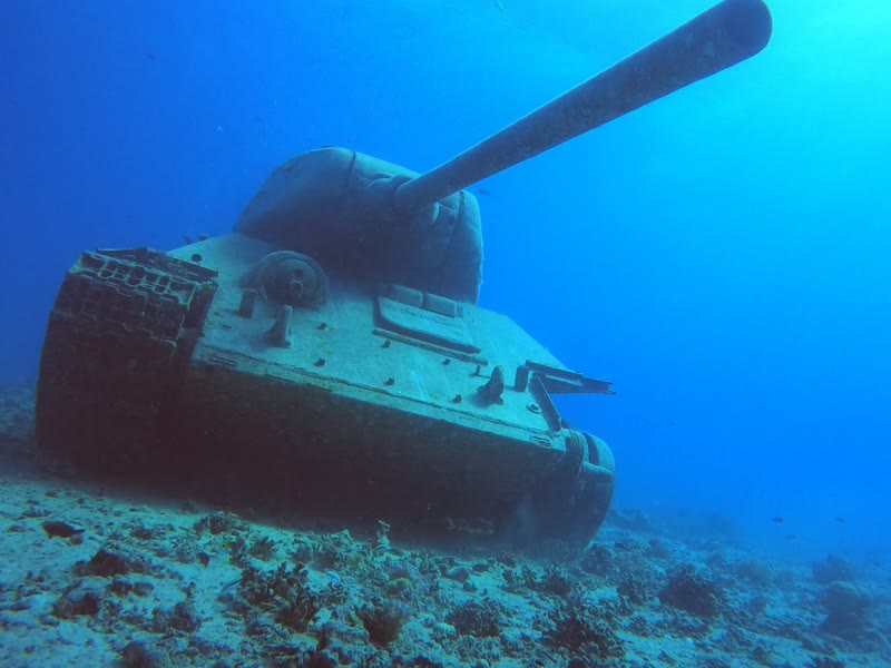 Group of divers above a wreck on the seabed